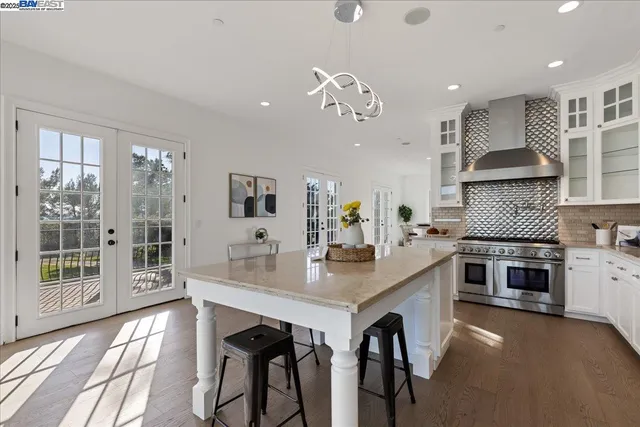 a open kitchen with cabinets and stainless steel appliances
