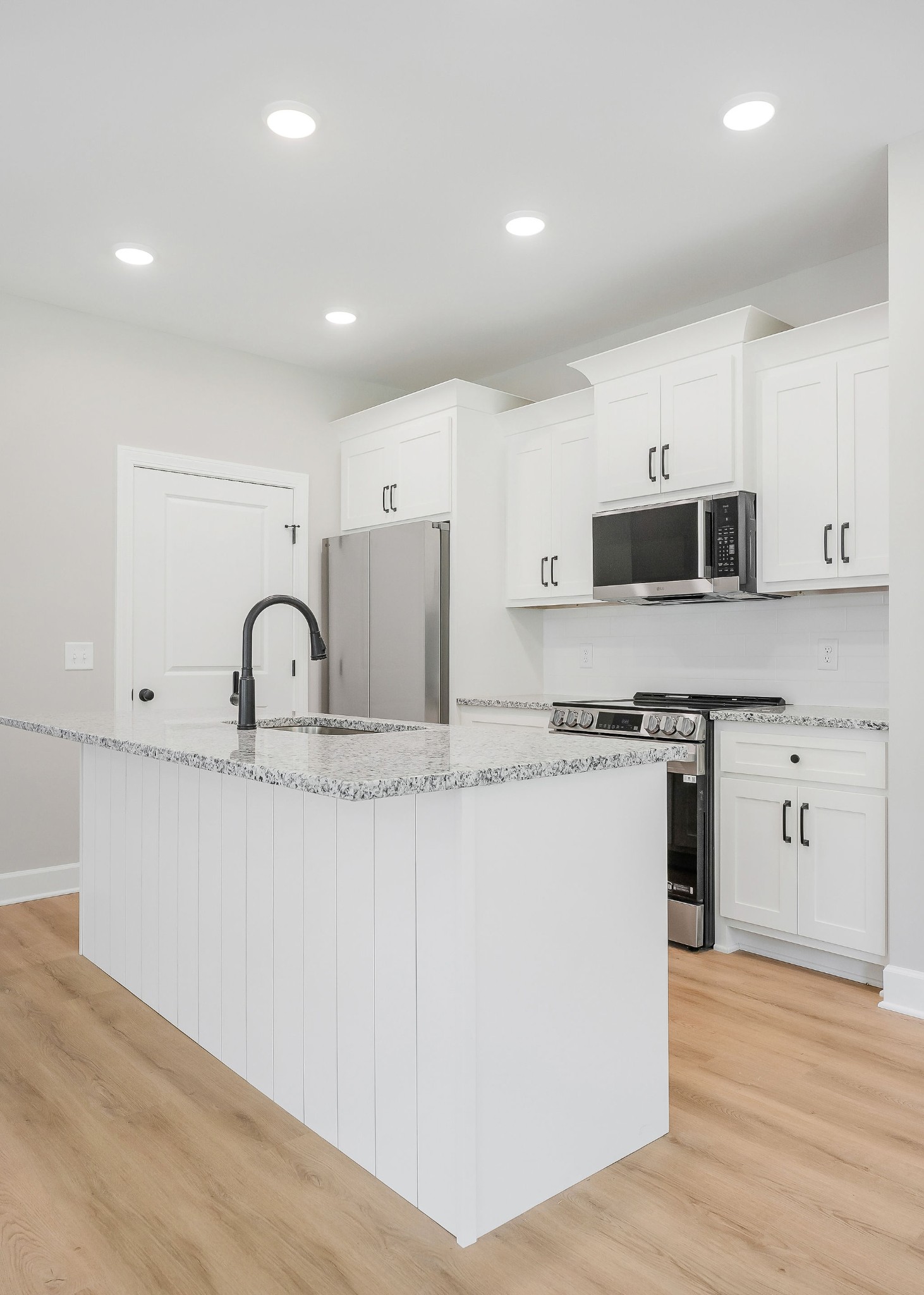 125 Reece Road Baxter, TN 38544 - Photo 20 of 31 a kitchen with stainless steel appliances white cabinets a sink and a stove