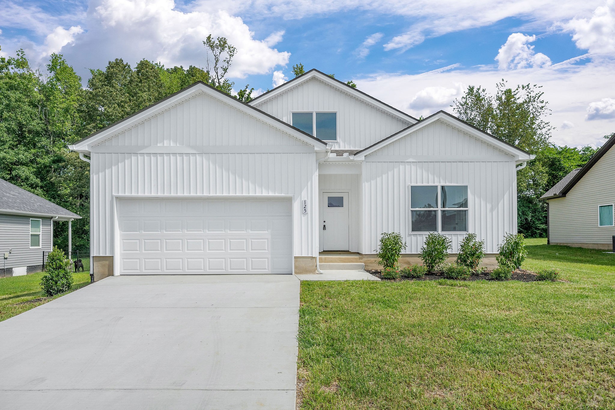 125 Reece Road Baxter, TN 38544 - Photo 31 of 31 a front view of a house with a yard and garage
