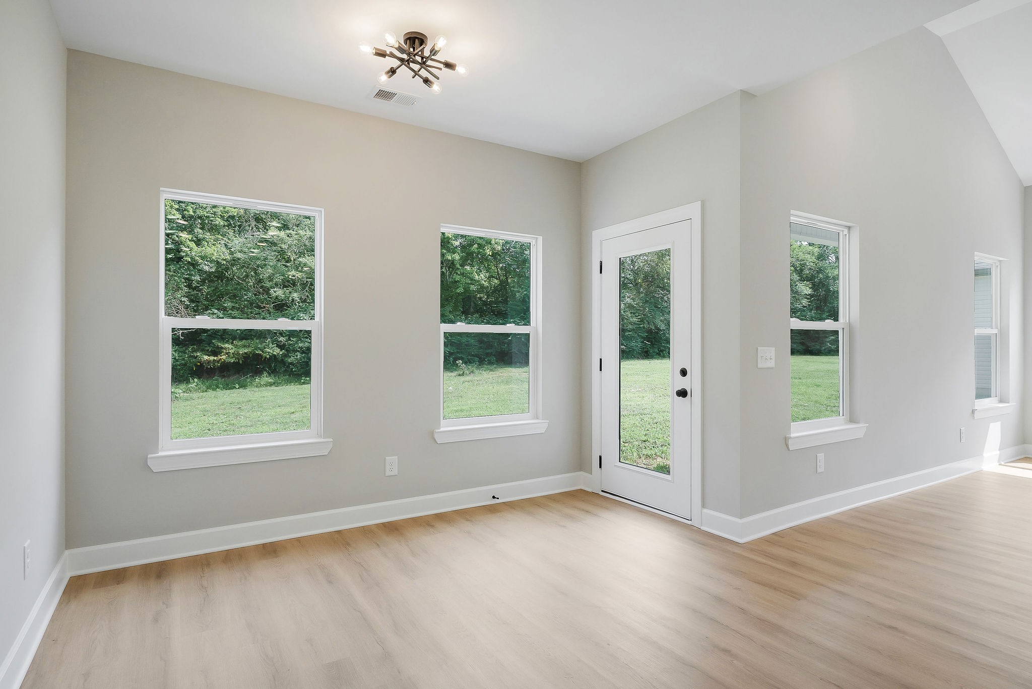 125 Reece Road Baxter, TN 38544 - Photo 8 of 31 an empty room with wooden floor and windows