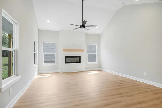 a view of a livingroom with a fireplace and window