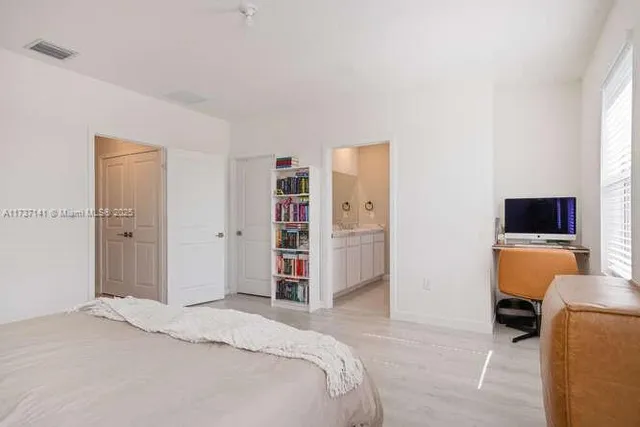 a bedroom with a bed and a television