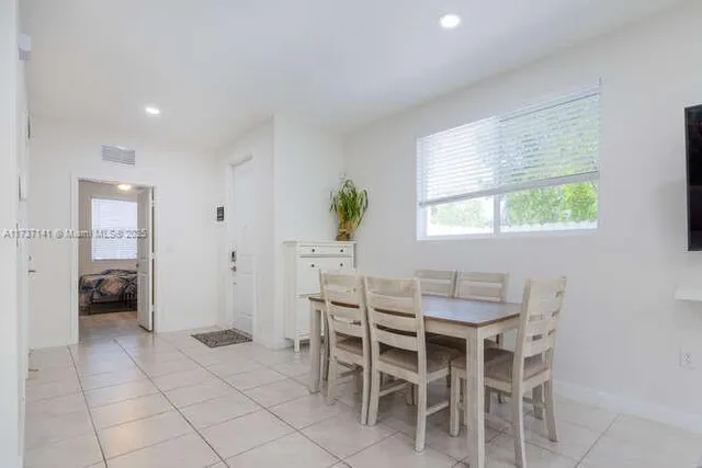 a dining room with furniture and window