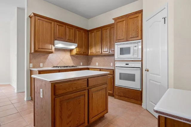 a kitchen with a stove and a refrigerator