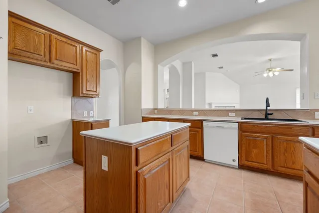 a kitchen that has a sink and a stove in it