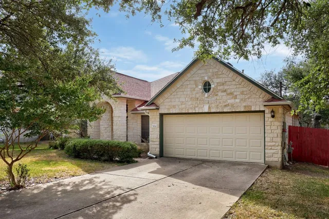 a front view of a house with plants