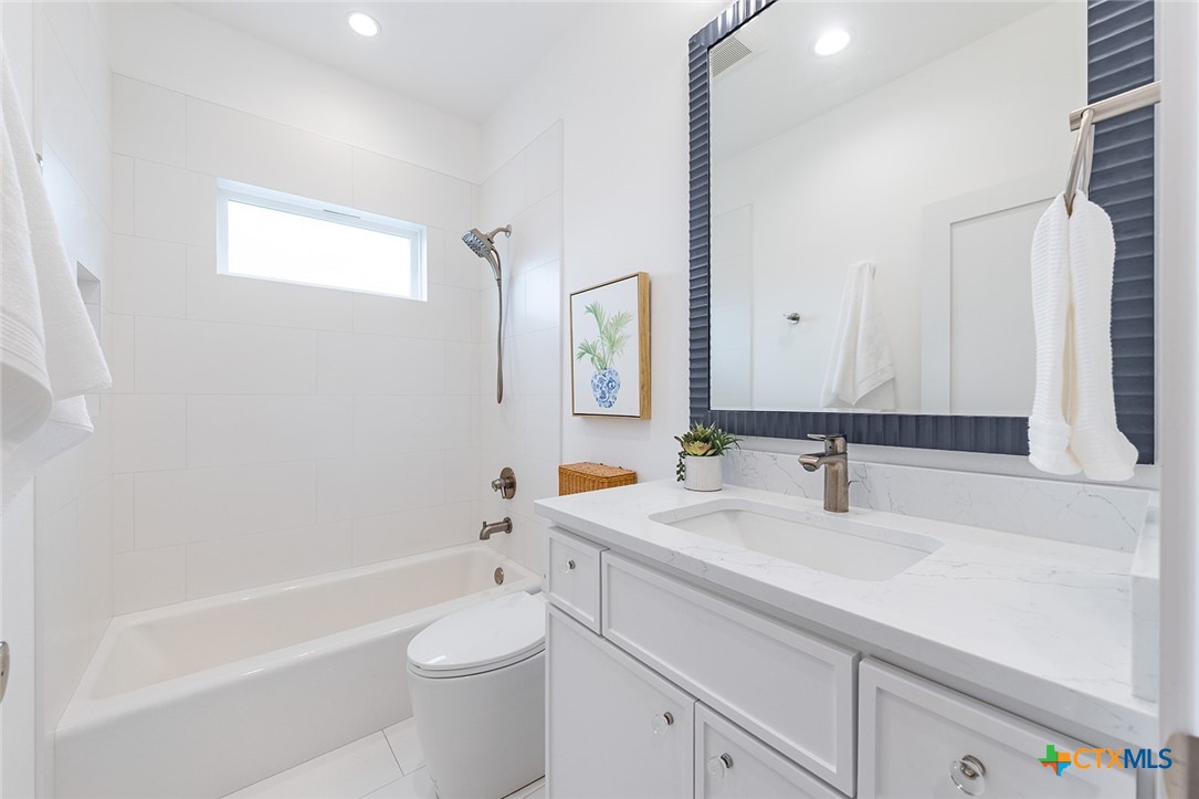 477 Willow Moon Ranch Road Crawford, TX 76638 - Photo 29 of 40 a bathroom with a sink a toilet and shower