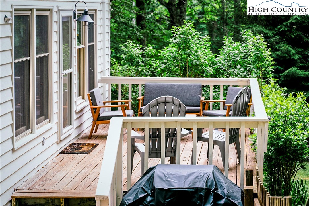 104 Woods Road Boone, NC 28607 - Photo 6 of 35 a view of a patio with table and chairs and potted plants