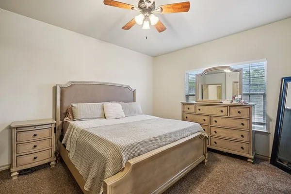 a bedroom with a bed and a dresser