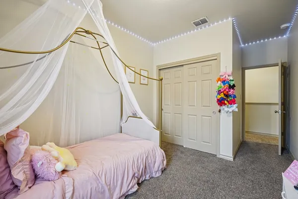 a bed room with a bed and a chandelier