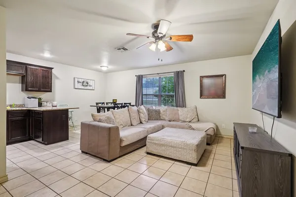 a living room with furniture and a flat screen tv