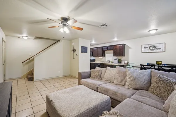 a living room with furniture and kitchen view