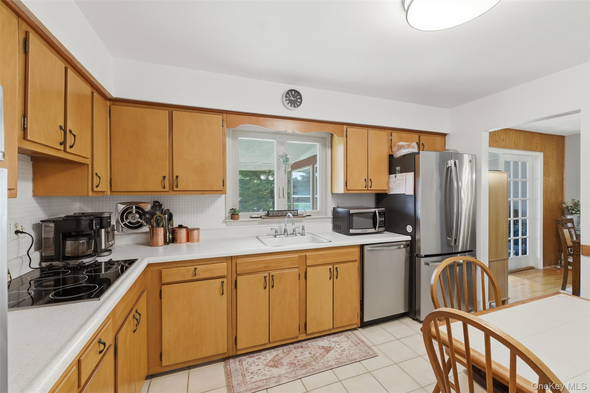 24 Beatty Road Wappingers Falls, NY 12590 - Photo 8 of 36 a kitchen with stainless steel appliances granite countertop a stove top oven a sink a refrigerator and cabinets