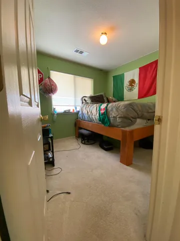 a bedroom with furniture and a window