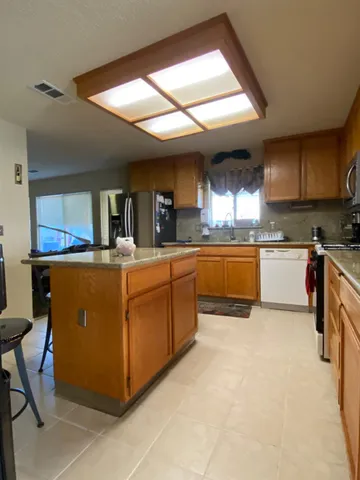 a large kitchen with cabinets and chairs
