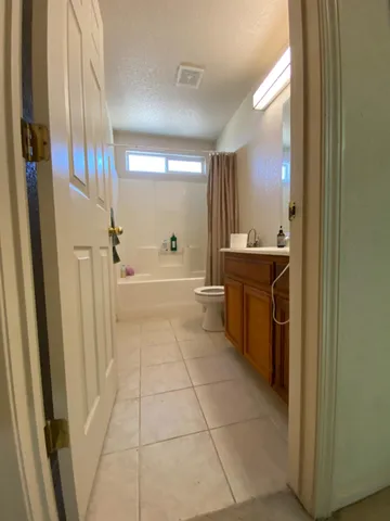 a spacious bathroom with a sink a mirror and a bathtub