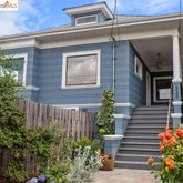 a front view of a house with plants