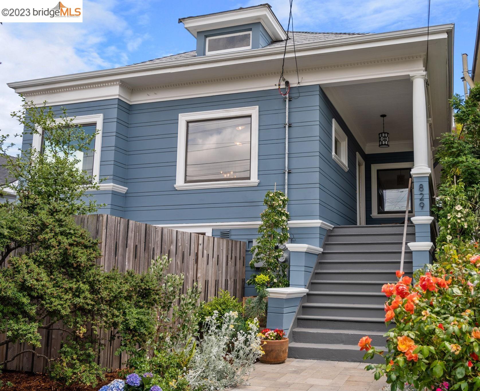 a front view of a house with plants