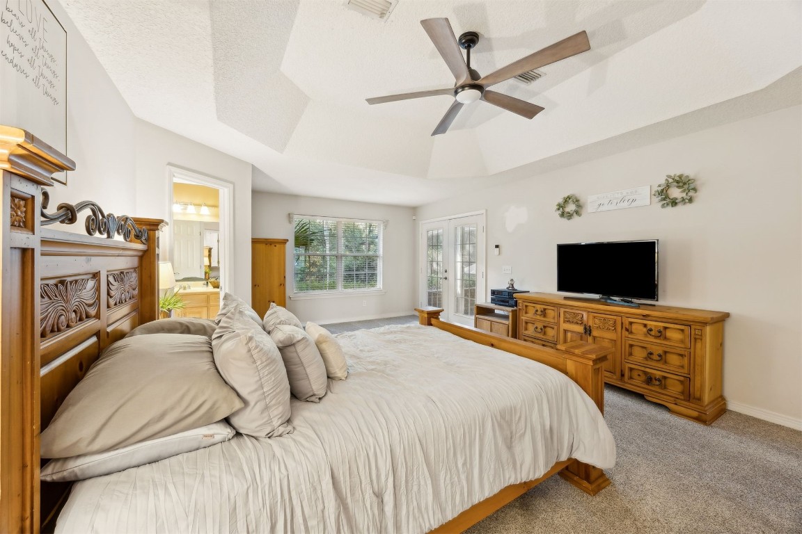 97535 Pirates Point Road Yulee, FL 32097 - Photo 26 of 59 a bedroom with a bed and a flat screen tv