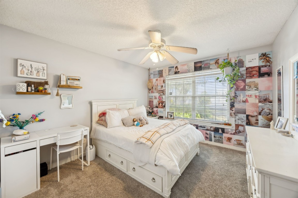 97535 Pirates Point Road Yulee, FL 32097 - Photo 31 of 59 a bedroom with a bed and a chandelier