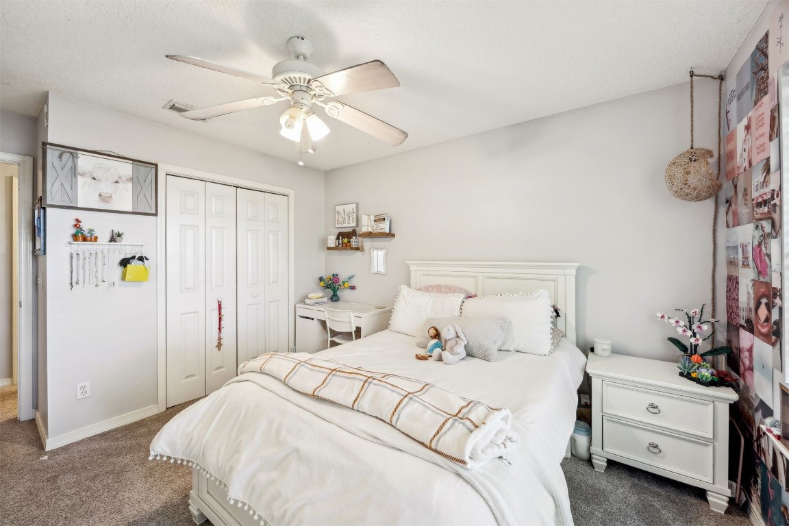 97535 Pirates Point Road Yulee, FL 32097 - Photo 32 of 59 a bedroom with a bed and a chandelier