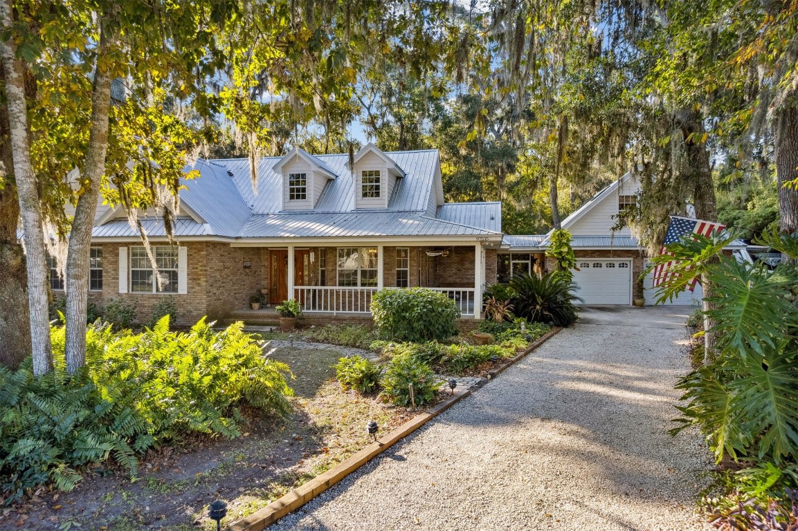 97535 Pirates Point Road Yulee, FL 32097 - Photo 51 of 59 a front view of a house with a yard and a garden