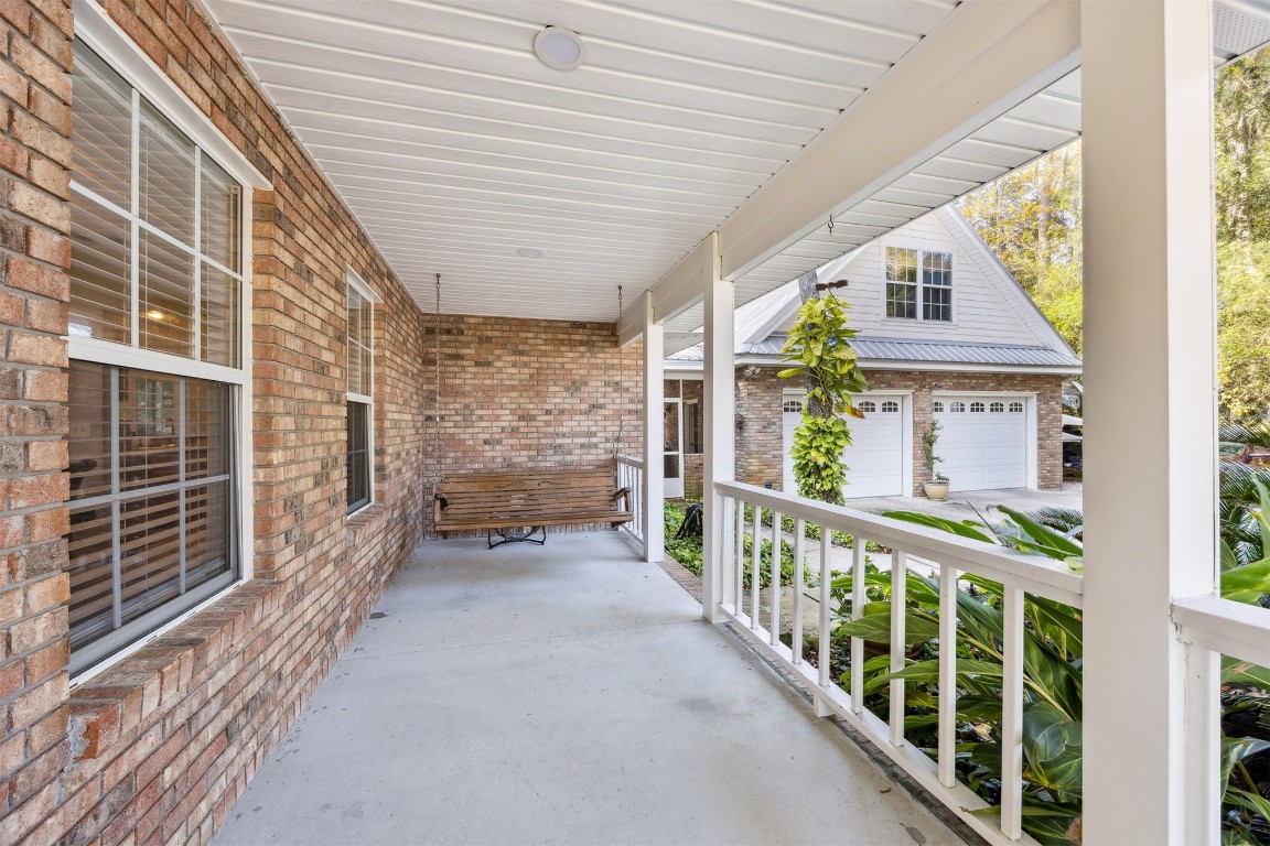97535 Pirates Point Road Yulee, FL 32097 - Photo 7 of 59 a view of a porch with wooden floor and fence