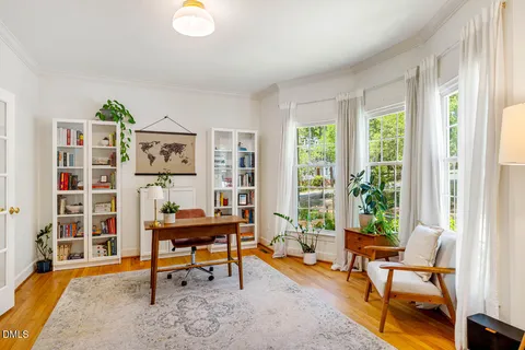 a living room with furniture and a floor to ceiling window