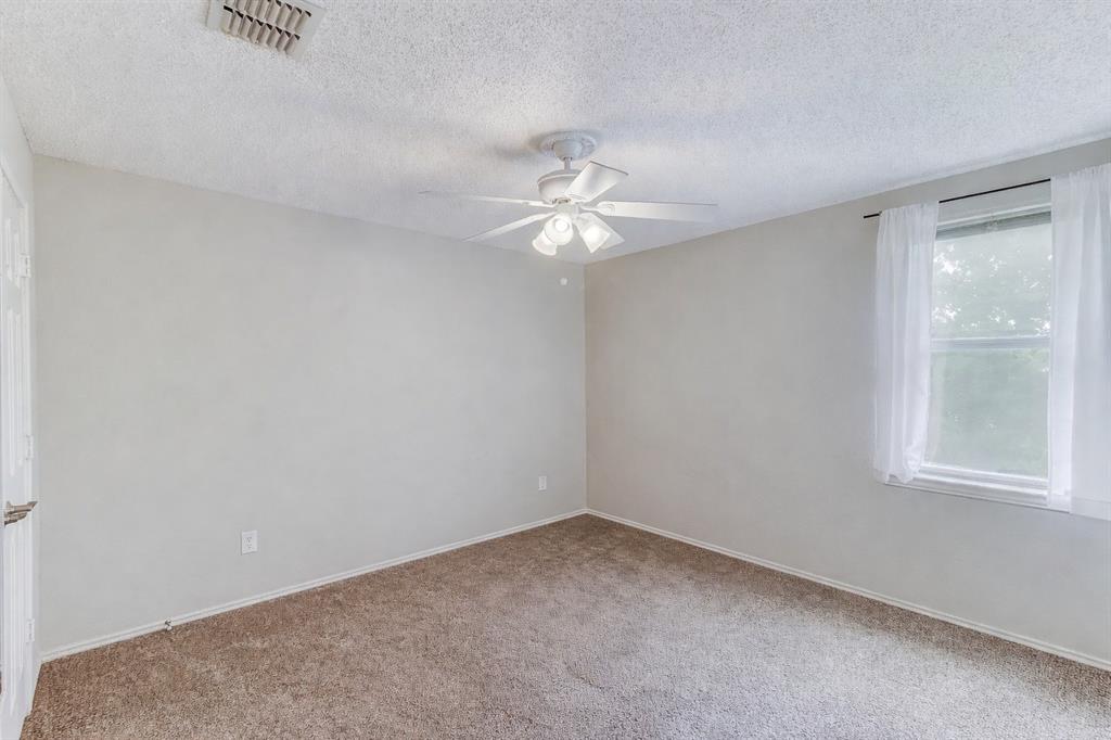 3601 McClintick Road McKinney, TX 75070 - Photo 22 of 24 an empty room with a window and a ceiling fan