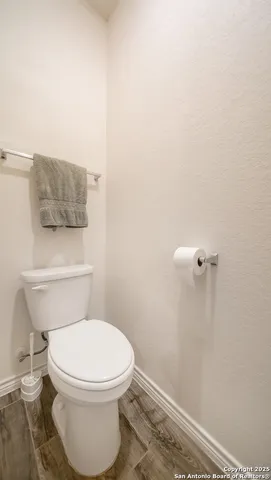 a white toilet sitting next to a shower