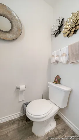 a white toilet sitting next to a bathroom sink and vanity