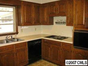 3105 Gilboa Road Wingate, NC 28174 - Photo 4 of 8 a kitchen with a sink cabinets and wooden floor