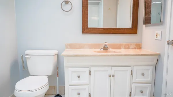 a bathroom with a toilet sink and mirror