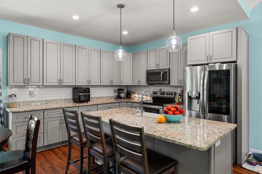 67 Sawblade Ridge Marietta, SC 29661 - Photo 11 of 37 Polished stone countertops pair elegantly with shaker cabinetry and a central prep island.