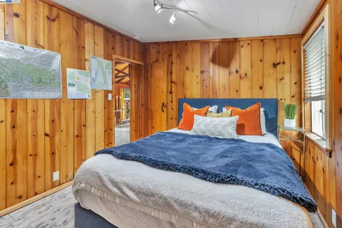 a large bed sitting in a bedroom next to a window