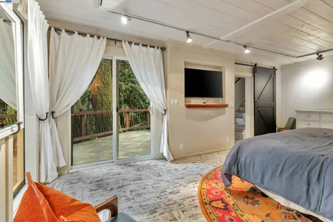 a bed room with a bed and a television