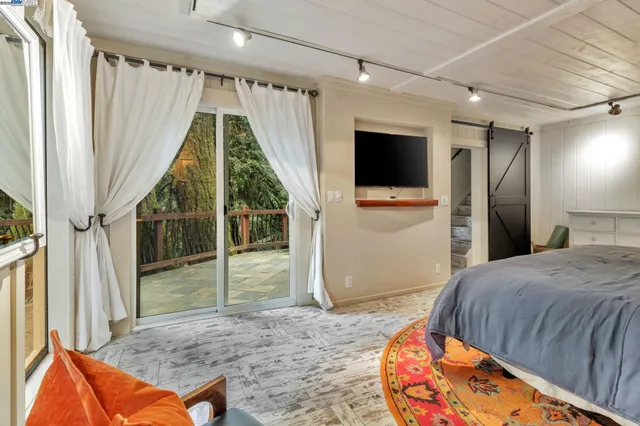 a bed room with a bed and a television