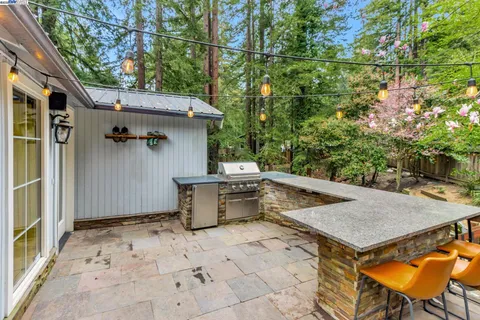 a view of a patio with table and chairs with wooden fence and plants