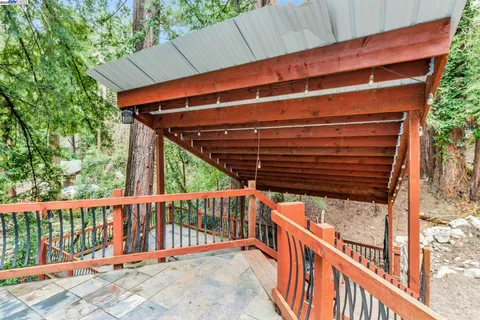 a view of balcony with wooden floor and fence