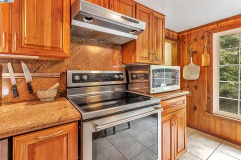 a kitchen with stainless steel appliances granite countertop a stove and a microwave oven