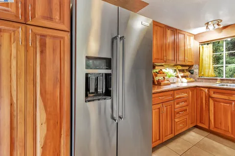 a kitchen with stainless steel appliances granite countertop a refrigerator and a sink