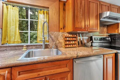 a kitchen with granite countertop a sink and a window