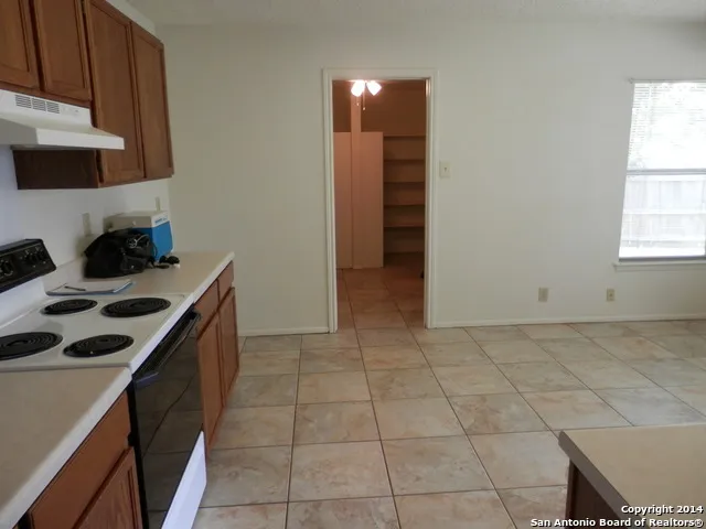 a kitchen with a sink a stove and cabinets