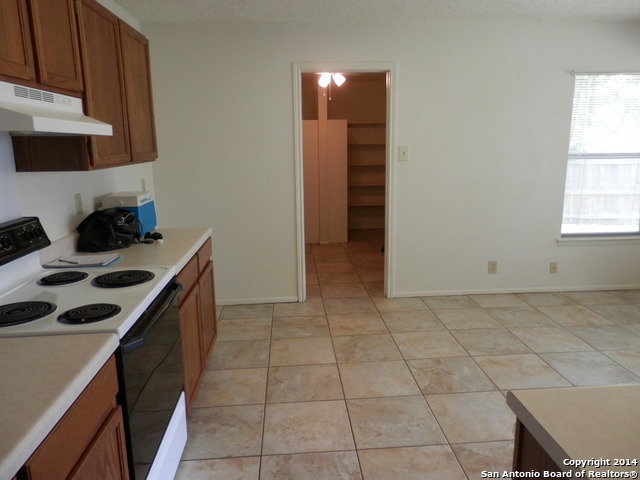 9655 Addersley Drive San Antonio, TX 78254 - Photo 16 of 20 a kitchen with a sink a stove and cabinets
