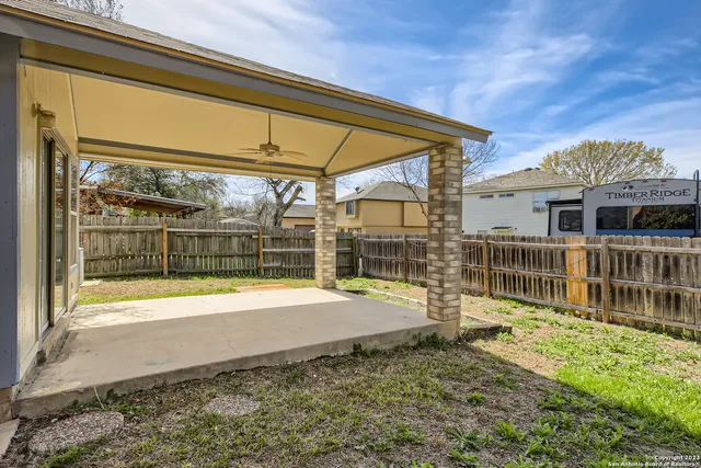 a view of a house with a backyard and a patio