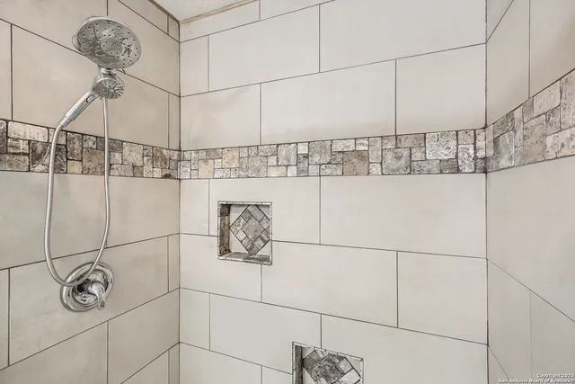 a bathroom with a shower and a shower head