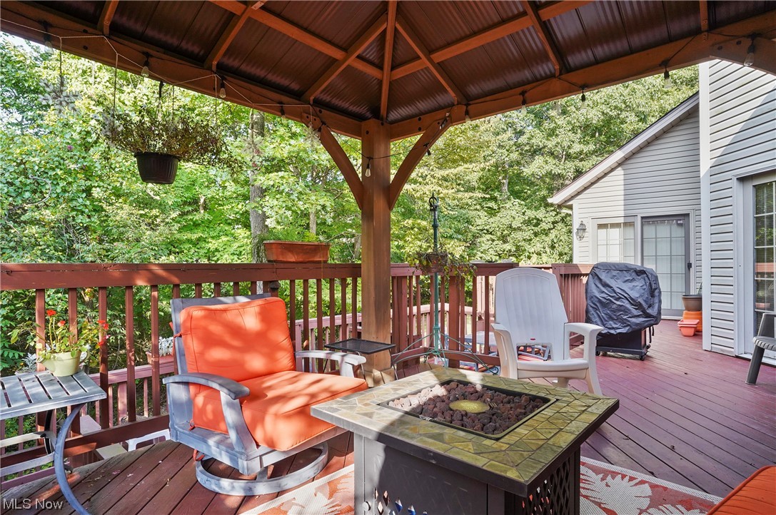 693 Timbercreek Road Northfield, OH 44067 - Photo 20 of 34 Wooden terrace with a gazebo and a firepit