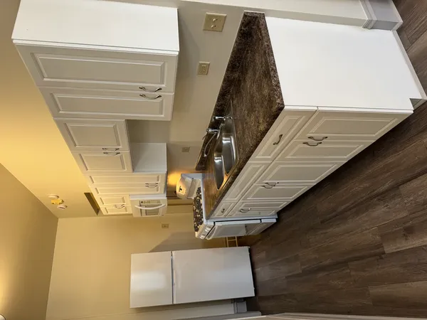 a stove top oven sitting inside of a kitchen