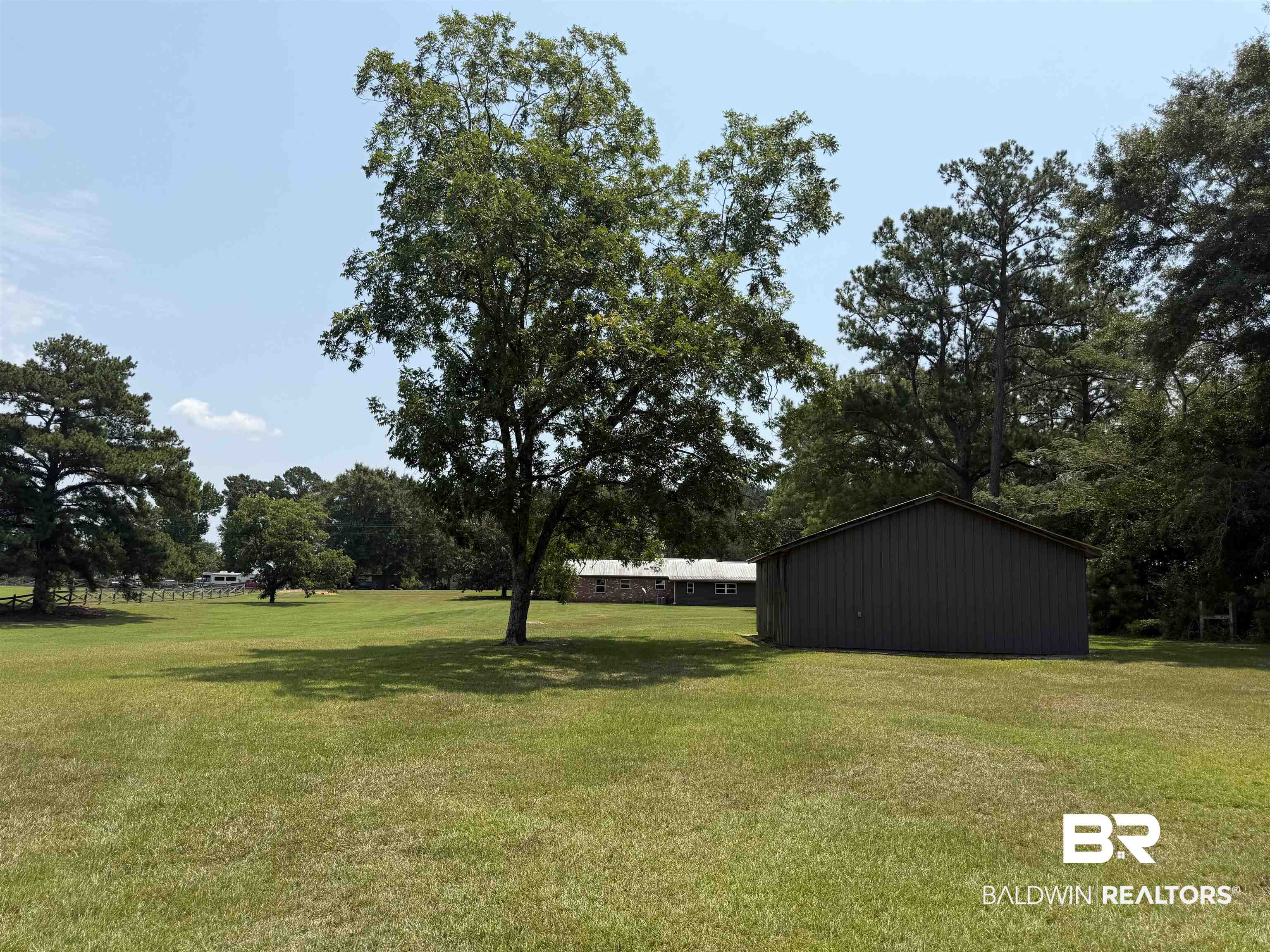 11115 Appleton Road Castleberry, AL 36432 - Photo 16 of 18 Expansive grassy grounds featuring mature trees and a detached outbuilding with vertical siding