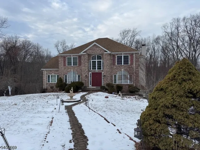 a front view of a house with yard covered in snow